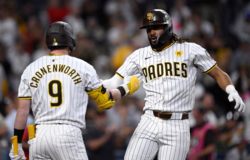 Jun 20, 2024; San Diego, California, USA; San Diego Padres right fielder Fernando Tatis Jr. (right) celebrates with second baseman Jake Cronenworth (9) after hitting a home run against the Milwaukee Brewers during the fifth inning at Petco Park. Mandatory Credit: Orlando Ramirez-USA TODAY Sports