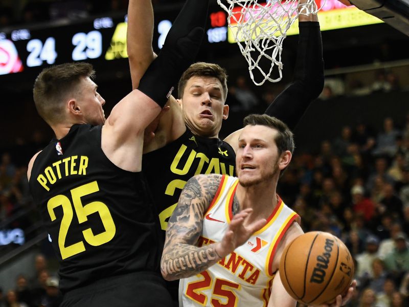 SALT LAKE CITY, UTAH - MARCH 15: Garrison Mathews #25 of the Atlanta Hawks passes around Micah Potter #25 and Walker Kessler #24 of the Utah Jazz during the first half of a game at Delta Center on March 15, 2024 in Salt Lake City, Utah.  NOTE TO USER: User expressly acknowledges and agrees that, by downloading and or using this photograph, User is consenting to the terms and conditions of the Getty Images License Agreement.  (Photo by Alex Goodlett/Getty Images)
