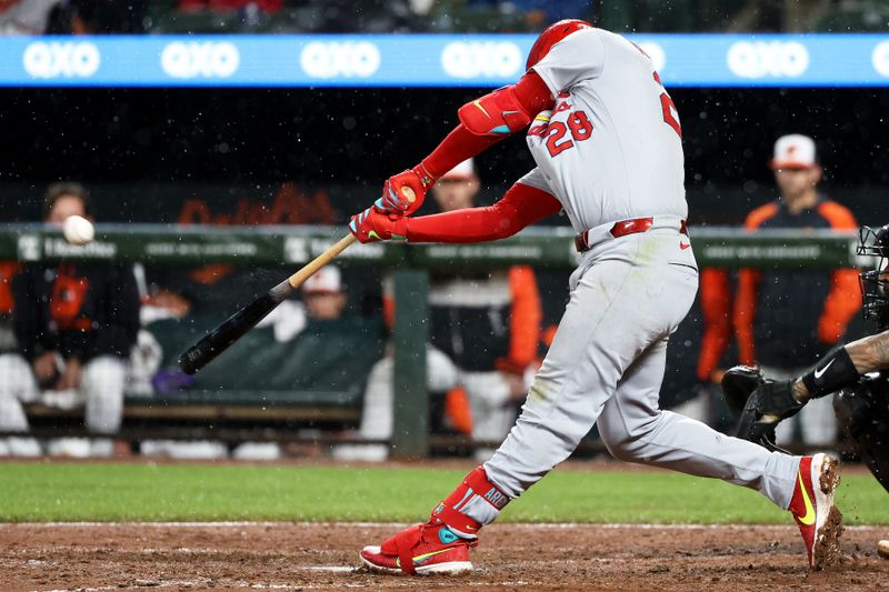 May 27, 2025; Baltimore, Maryland, USA; St. Louis Cardinals third baseman Nolan Arenado (28) hits a home run during the eighth inning against the Baltimore Orioles at Oriole Park at Camden Yards. Mandatory Credit: Daniel Kucin Jr.-Imagn Images