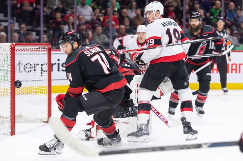 Mar 17, 2024; Ottawa, Ontario, CAN; Carolina Hurricanes defenseman Jacob Slavin (74) follows the puck in the first period against the Ottawa Senators at the Canadian Tire Centre. Mandatory Credit: Marc DesRosiers-USA TODAY Sports