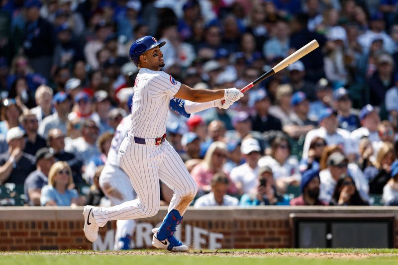 May 3, 2024; Chicago, Illinois, USA; Chicago Cubs third baseman Christopher Morel (5) hits a solo home run against the Milwaukee Brewers during the sixth inning at Wrigley Field. Mandatory Credit: Kamil Krzaczynski-USA TODAY Sports