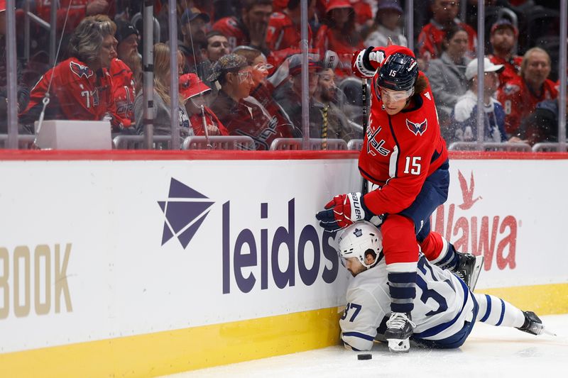 Oct 24, 2023; Washington, District of Columbia, USA; Washington Capitals left wing Sonny Milano (15) checks Toronto Maple Leafs defenseman Timothy Liljegren (37) while battling for the puck in the third period at Capital One Arena. Mandatory Credit: Geoff Burke-USA TODAY Sports