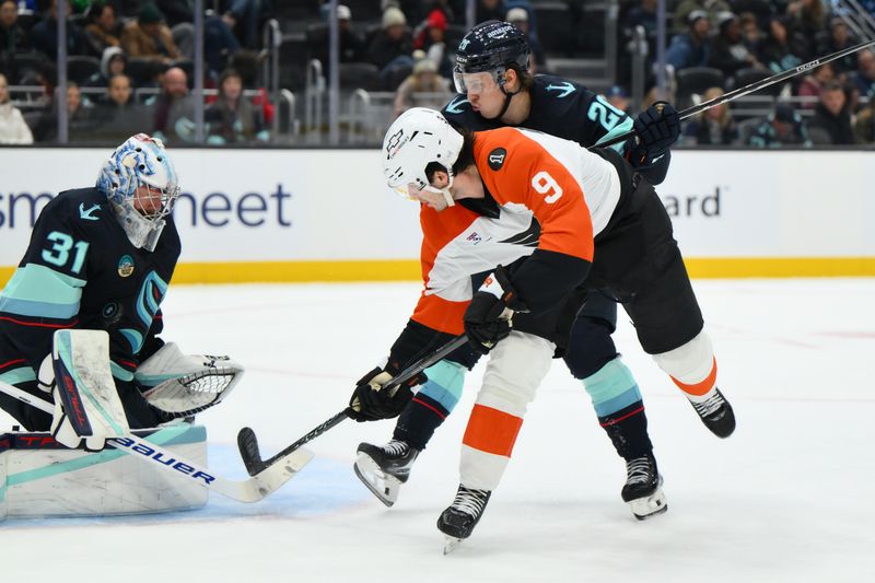 Dec 28, 2025; Seattle, Washington, USA; Seattle Kraken goaltender Philipp Grubauer (31) blocks a goal shot by Philadelphia Flyers defenseman Jamie Drysdale (9) during the third period at Climate Pledge Arena. Mandatory Credit: Steven Bisig-Imagn Images