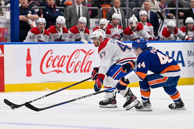 Apr 11, 2024; Elmont, New York, USA; New York Islanders center Jean-Gabriel Pageau (44) defends against Montreal Canadiens defenseman Jayden Struble (47) during the first period at UBS Arena. Mandatory Credit: Dennis Schneidler-USA TODAY Sports