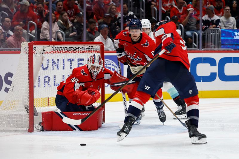 Oct 21, 2025; Washington, District of Columbia, USA; Washington Capitals goaltender Logan Thompson (48) makes a save against in front of Capitals defenseman Jakob Chychrun (6) and Seattle Kraken center Chandler Stephenson (9) during the second period at Capital One Arena. Mandatory Credit: Geoff Burke-Imagn Images