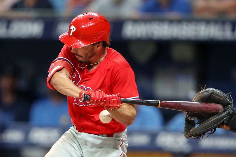 Jul 6, 2023; St. Petersburg, Florida, USA;  Philadelphia Phillies catcher Garrett Stubbs (21) is hit by a pitch against the Tampa Bay Rays in the eleventh inning at Tropicana Field. Mandatory Credit: Nathan Ray Seebeck-USA TODAY Sports