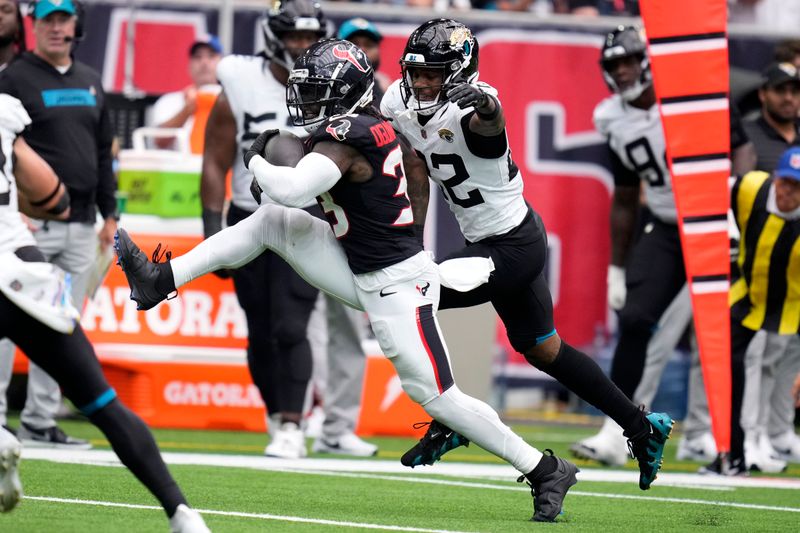 Houston Texans running back Dare Ogunbowale (33) runs from Jacksonville Jaguars cornerback Jarrian Jones (22) during the second half of an NFL football game, Sunday, Sept. 29, 2024, in Houston. (AP Photo/Eric Christian Smith)