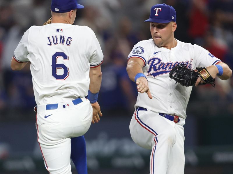 Aug 19, 2024; Arlington, Texas, USA; Texas Rangers third baseman Josh Jung (6) and first baseman Nathaniel Lowe (30) celebrate after the game against the Pittsburgh Pirates at Globe Life Field. Mandatory Credit: Tim Heitman-USA TODAY Sports