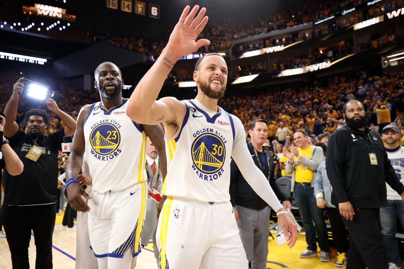 SAN FRANCISCO, CALIFORNIA - APRIL 23: Stephen Curry #30 of the Golden State Warriors goes to high-five Klay Thompson #11 after they beat the Sacramento Kings in Game Four of the Western Conference First Round Playoffs at Chase Center on April 23, 2023 in San Francisco, California. NOTE TO USER: User expressly acknowledges and agrees that, by downloading and or using this photograph, User is consenting to the terms and conditions of the Getty Images License Agreement. (Photo by Ezra Shaw/Getty Images)