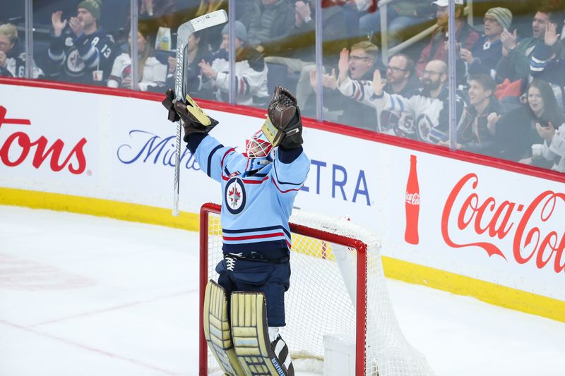 Dec 4, 2023; Winnipeg, Manitoba, CAN; Winnipeg Jets goalie Laurent Boissoit (39) celebrates the win against the Carolina Hurricanes at the end of the third period at Canada Life Centre. Mandatory Credit: Terrence Lee-USA TODAY Sports