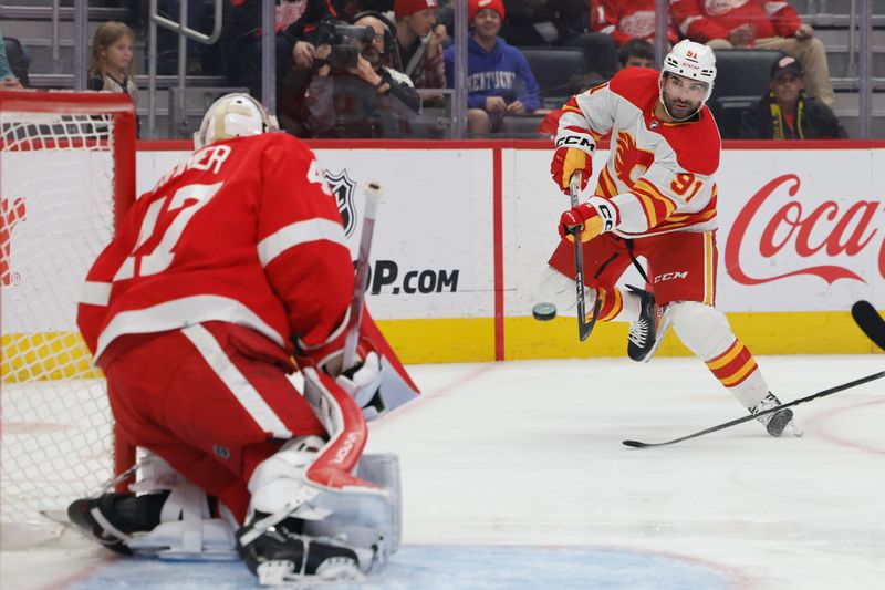 Oct 22, 2023; Detroit, Michigan, USA;  Calgary Flames center Nazem Kadri (91) takes a shot on Detroit Red Wings goaltender James Reimer (47) in the first period at Little Caesars Arena. Mandatory Credit: Rick Osentoski-USA TODAY Sports