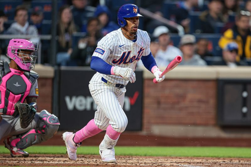 May 12, 2024; New York City, New York, USA; New York Mets shortstop Francisco Lindor (12) singles during the third inning against the Atlanta Braves at Citi Field. Mandatory Credit: Vincent Carchietta-USA TODAY Sports