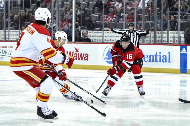 Feb 8, 2024; Newark, New Jersey, USA; New Jersey Devils left wing Ondrej Palat (18) skates with the puck while being defended by Calgary Flames center Jakob Pelletier (22) and Calgary Flames defenseman Rasmus Andersson (4) during the second period at Prudential Center. Mandatory Credit: John Jones-USA TODAY Sports