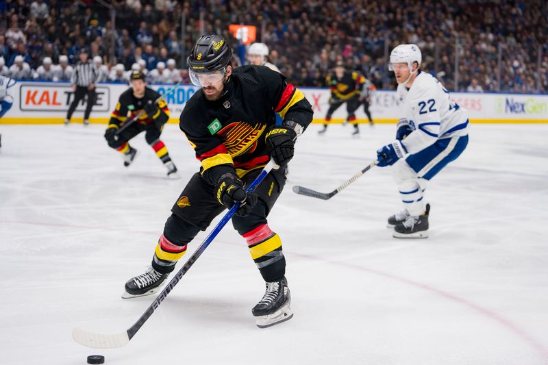 Jan 20, 2024; Vancouver, British Columbia, CAN; Vancouver Canucks forward Conor Garland (8) handles the puck against the Toronto Maple Leafs in the first period at Rogers Arena. Mandatory Credit: Bob Frid-USA TODAY Sports