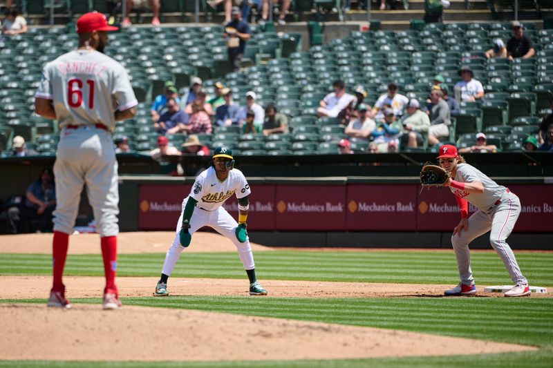 Jun 17, 2023; Oakland, California, USA; Oakland Athletics outfielder Esteury Ruiz (1) leads away from first base against Philadelphia Phillies pitcher Cristopher Sanchez (61) and infielder Alec Bohm (28) during the fourth inning at Oakland-Alameda County Coliseum. Mandatory Credit: Robert Edwards-USA TODAY Sports