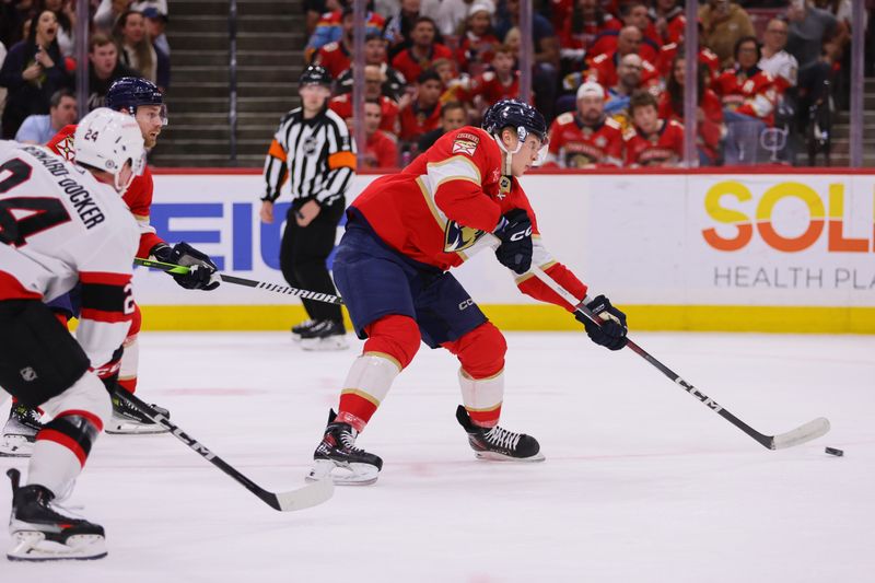 Apr 9, 2024; Sunrise, Florida, USA; Florida Panthers center Anton Lundell (15) shoots the puck and scores against the Ottawa Senators during the first period at Amerant Bank Arena. Mandatory Credit: Sam Navarro-USA TODAY Sports