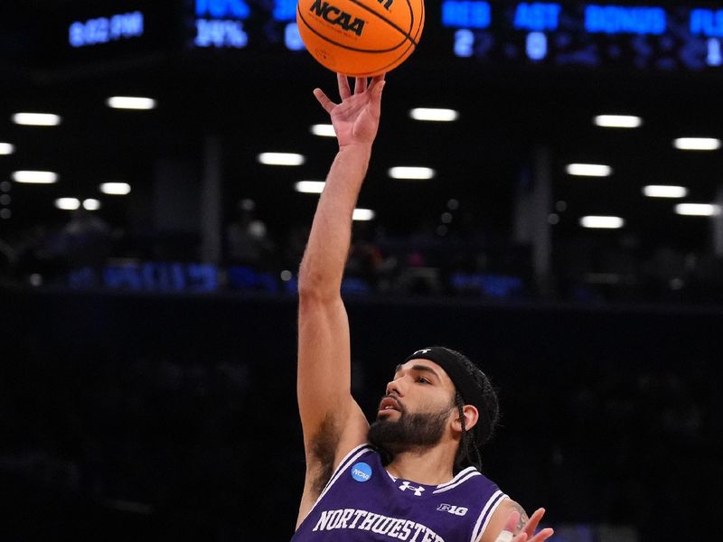 Mar 24, 2024; Brooklyn, NY, USA; Northwestern Wildcats guard Boo Buie (0) shoots the ball against the Connecticut Huskies in the second round of the 2024 NCAA Tournament at the Barclays Center. Mandatory Credit: Robert Deutsch-USA TODAY Sports