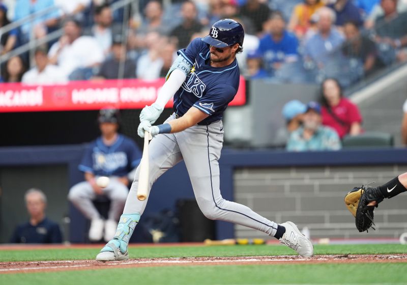 Jul 23, 2024; Toronto, Ontario, CAN; Tampa Bay Rays right fielder Josh Lowe (15) hits a single against the Toronto Blue Jays during the second inning at Rogers Centre. Mandatory Credit: Nick Turchiaro-USA TODAY Sports