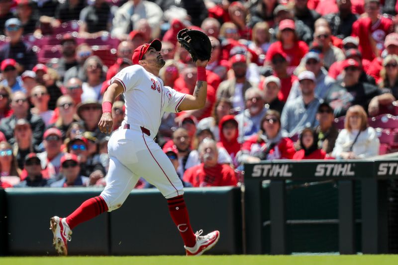 Apr 25, 2024; Cincinnati, Ohio, USA; Cincinnati Reds first baseman Christian Encarnacion-Strand (33) catches a pop up hit by Philadelphia Phillies third baseman Alec Bohm (not pictured) in the second inning at Great American Ball Park. Mandatory Credit: Katie Stratman-USA TODAY Sports