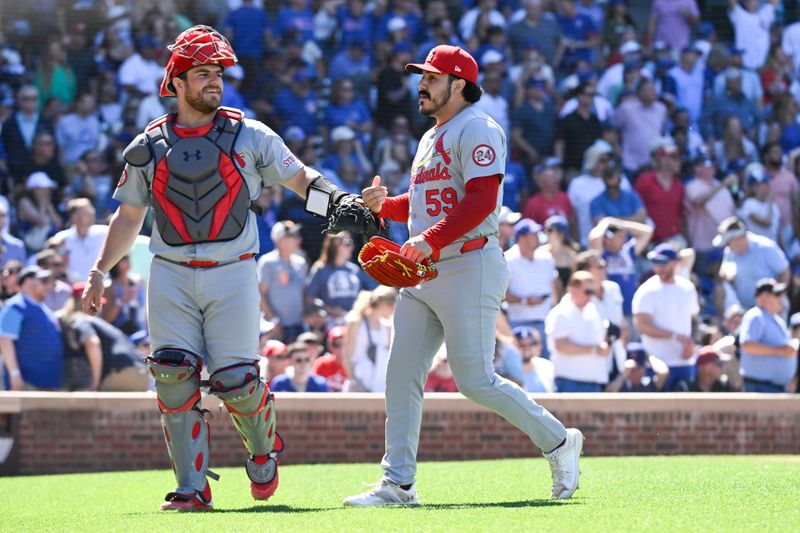 Jun 14, 2024; Chicago, Illinois, USA;  St. Louis Cardinals catcher Pedro Pages (43) and pitcher JoJo Romero (59) high five after the eighth inning against the Chicago Cubs at Wrigley Field. Mandatory Credit: Matt Marton-USA TODAY Sports