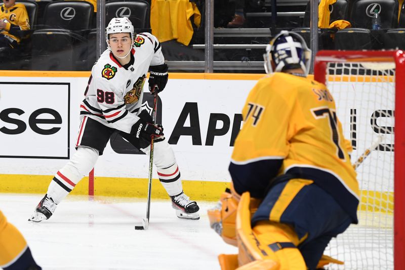 Jan 2, 2024; Nashville, Tennessee, USA; Chicago Blackhawks center Connor Bedard (98) looks to pass the puck during the second period against the Nashville Predators at Bridgestone Arena. Mandatory Credit: Christopher Hanewinckel-USA TODAY Sports