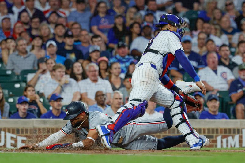 Aug 5, 2024; Chicago, Illinois, USA; Minnesota Twins second baseman Willi Castro (50) scores against Chicago Cubs catcher Miguel Amaya (9) during the third inning at Wrigley Field. Mandatory Credit: Kamil Krzaczynski-USA TODAY Sports