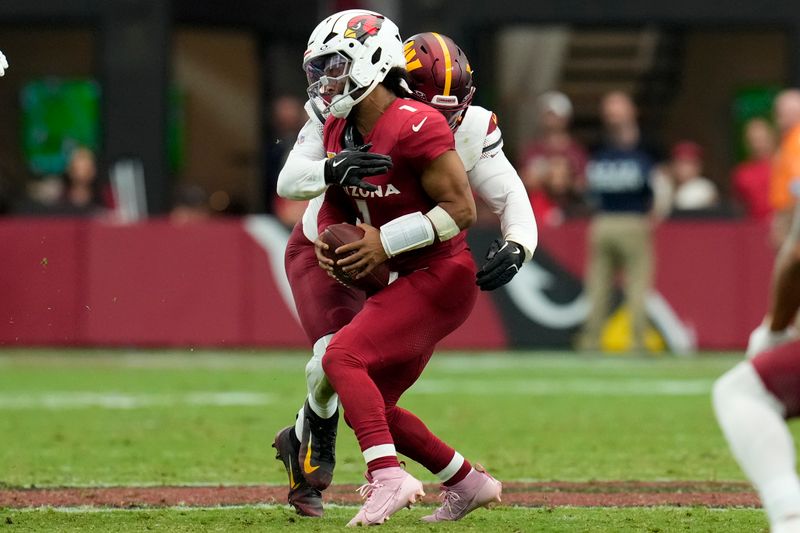 Arizona Cardinals quarterback Kyler Murray (1) is sacked by Washington Commanders defensive end Dorance Armstrong (92) during the first half of an NFL football game, Sunday, Sept. 29, 2024, in Glendale, Ariz. (AP Photo/Ross D. Franklin)