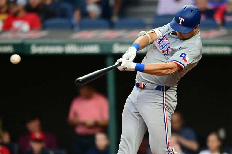 Aug 23, 2024; Cleveland, Ohio, USA; Texas Rangers first baseman Nathaniel Lowe (30) hits a single during the third inning against the Cleveland Guardians at Progressive Field. Mandatory Credit: Ken Blaze-USA TODAY Sports