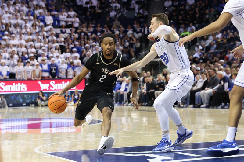 Feb 13, 2024; Provo, Utah, USA; Central Florida Knights guard Shemarri Allen (2) drives against Brigham Young Cougars guard Spencer Johnson (20) during the first half at Marriott Center. Mandatory Credit: Rob Gray-USA TODAY Sports