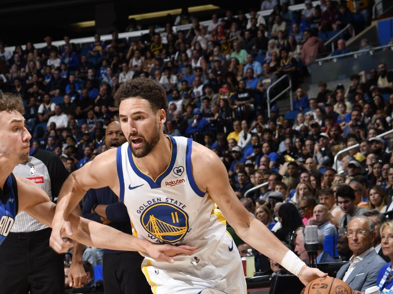ORLANDO, FL - MARCH 27: Klay Thompson #11 of the Golden State Warriors handles the ball during the game against the Orlando Magic on March 27, 2024 at Amway Center in Orlando, Florida. NOTE TO USER: User expressly acknowledges and agrees that, by downloading and or using this photograph, User is consenting to the terms and conditions of the Getty Images License Agreement. Mandatory Copyright Notice: Copyright 2024 NBAE (Photo by Fernando Medina/NBAE via Getty Images)