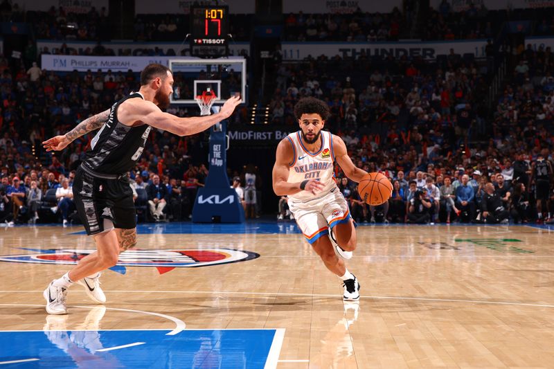 OKLAHOMA CITY, OK - OCTOBER 30: Ajay Mitchell #25 of the Oklahoma City Thunder handles the ball during the game against the San Antonio Spurs on October 30, 2024 at Paycom Arena in Oklahoma City, Oklahoma. NOTE TO USER: User expressly acknowledges and agrees that, by downloading and or using this photograph, User is consenting to the terms and conditions of the Getty Images License Agreement. Mandatory Copyright Notice: Copyright 2024 NBAE (Photo by Zach Beeker/NBAE via Getty Images)