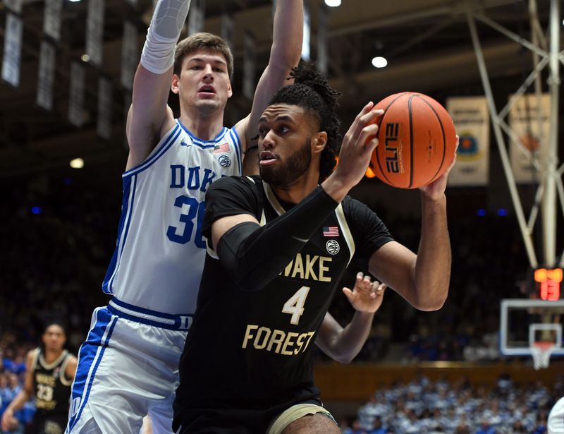 Feb 12, 2024; Durham, North Carolina, USA;  Wake Forest Deamon Deacons center Efton Reid III (4) looks to shoot as Duke Blue Devils center Kyle Filipowski (30) defends during the first half at Cameron Indoor Stadium. Mandatory Credit: Rob Kinnan-USA TODAY Sports