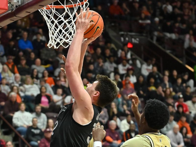 Jan 27, 2026; Blacksburg, Virginia, USA;  Virginia Tech Hokies center Christian Gurdak (32) shoots a shot defended by Georgia Tech Yellow Jackets guard Chas Kelley III (7) during the second half at Cassell Coliseum. Mandatory Credit: Brian Bishop-Imagn Images