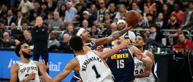 AUSTIN, TX - MARCH 15: Aaron Gordon #50 of the Denver Nuggets drives past Victor Wembanyama #1 of the San Antonio Spurs in the first half at Moody Center on March 15, 2024 in Austin, Texas. NOTE TO USER: User expressly acknowledges and agrees that, by downloading and or using this photograph, User is consenting to terms and conditions of the Getty Images License Agreement. (Photo by Ronald Cortes/Getty Images)