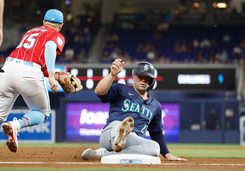 Jun 22, 2024; Miami, Florida, USA;  Seattle Mariners first baseman Ty France (23) slides into third base against the Miami Marlins in the first inning at loanDepot Park. Mandatory Credit: Rhona Wise-USA TODAY Sports