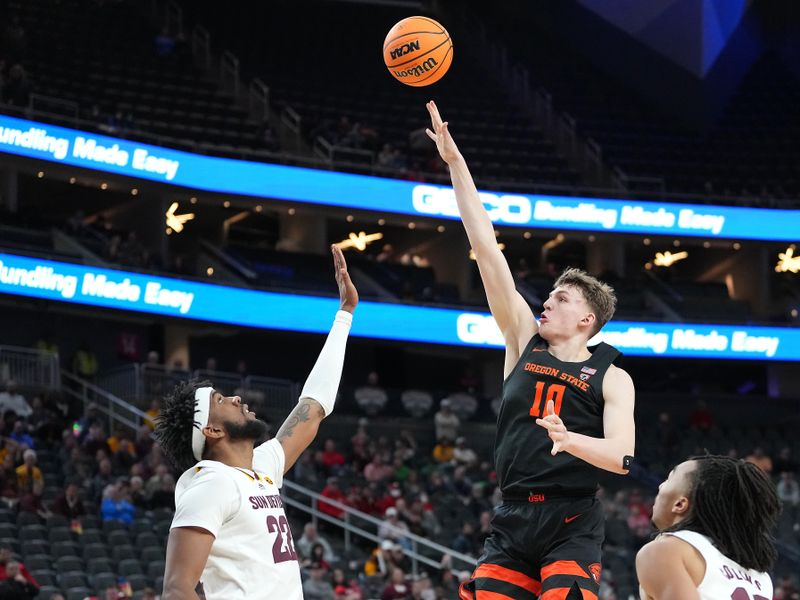 Mar 8, 2023; Las Vegas, NV, USA; Oregon State Beavers forward Tyler Bilodeau (10) shoots against Arizona State Sun Devils forward Warren Washington (22) during the second half at T-Mobile Arena. Mandatory Credit: Stephen R. Sylvanie-USA TODAY Sports