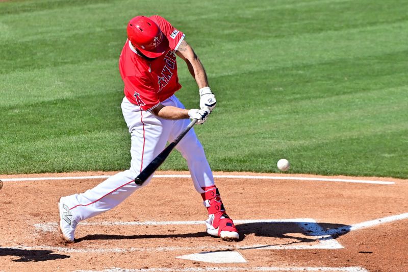 Feb 29, 2024; Tempe, Arizona, USA;  Los Angeles Angels third baseman Anthony Rendon (6) singles in the fourth inning against the Cleveland Guardians during a spring training game at Tempe Diablo Stadium. Mandatory Credit: Matt Kartozian-USA TODAY Sports