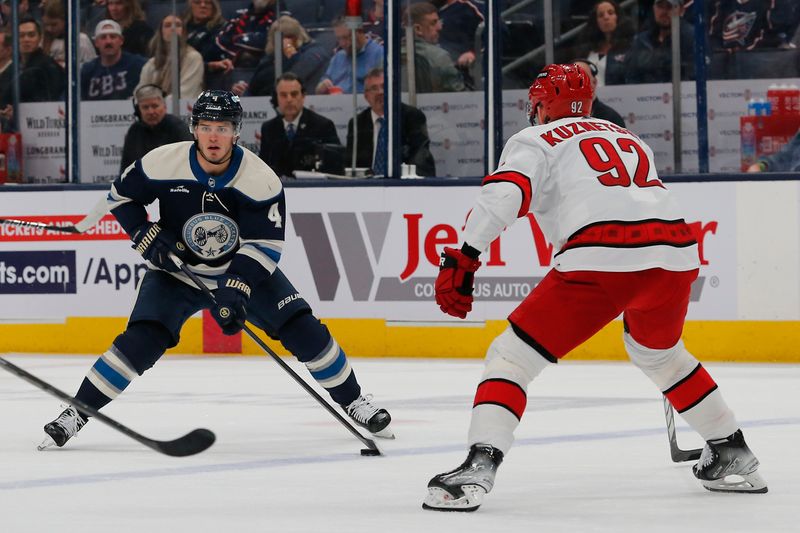 Apr 16, 2024; Columbus, Ohio, USA; Columbus Blue Jackets Forward Cole Sillinger (4) looks to pass as Carolina Hurricanes center Evgeny Kuznetsov (92) defends during the second period at Nationwide Arena. Mandatory Credit: Russell LaBounty-USA TODAY Sports