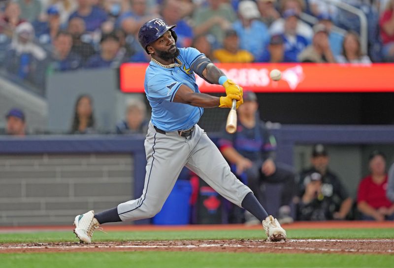 Jul 24, 2024; Toronto, Ontario, CAN; Tampa Bay Rays left fielder Randy Arozarena (56) hits a double against the Toronto Blue Jays during the fifth inning at Rogers Centre. Mandatory Credit: Nick Turchiaro-USA TODAY Sports