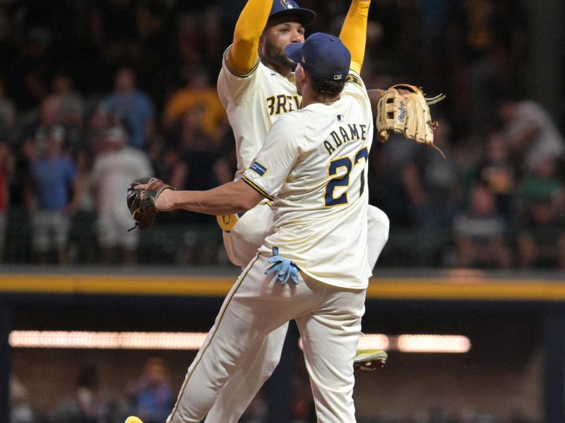 Jul 29, 2024; Milwaukee, Wisconsin, USA; Milwaukee Brewers outfielder Jackson Chourio (11) and Milwaukee Brewers shortstop Willy Adames (27) celebrate a 8-3 win over the Atlanta Braves at American Family Field. Mandatory Credit: Michael McLoone-USA TODAY Sports