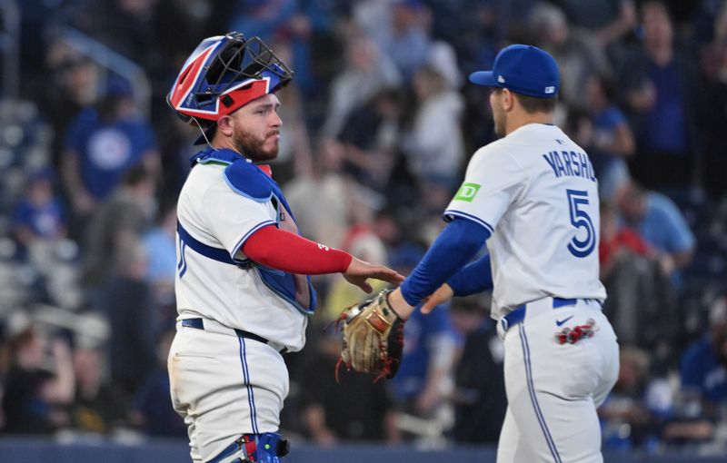 May 14, 2025; Toronto, Ontario, CAN;  Toronto Blue Jays catcher Alejandro Kirk (30) celebraes with center fielder Daulton Varsho (5) after a win over the Tampa Bay Rays at Rogers Centre. Mandatory Credit: Dan Hamilton-Imagn Images