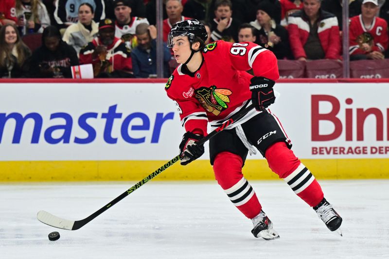 Nov 21, 2024; Chicago, Illinois, USA; Chicago Blackhawks center Connor Bedard (98) skates with the puck against the Florida Panthers during the first period at the United Center. Mandatory Credit: Daniel Bartel-Imagn Images