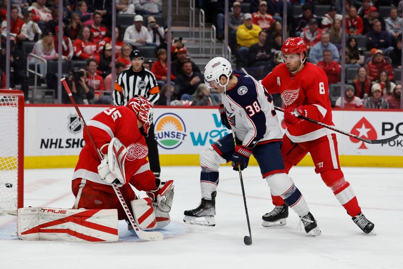 Nov 11, 2023; Detroit, Michigan, USA;  Columbus Blue Jackets center Boone Jenner (38) and Detroit Red Wings defenseman Ben Chiarot (8) fight for position in front of goaltender Ville Husso (35) in the third period at Little Caesars Arena. Mandatory Credit: Rick Osentoski-USA TODAY Sports