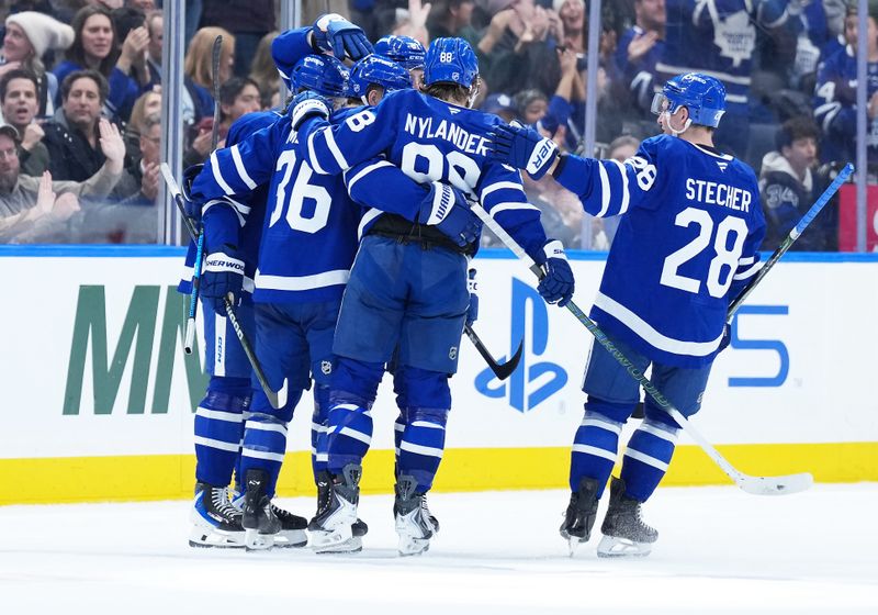 Nov 20, 2025; Toronto, Ontario, CAN; Toronto Maple Leafs defenseman Dakota Mermis (36) scores a goal and celebrates with right wing William Nylander (88) against the Columbus Blue Jackets during the second period at Scotiabank Arena. Mandatory Credit: Nick Turchiaro-Imagn Images