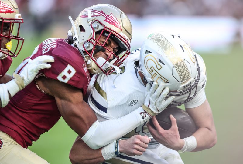 Aug 24, 2024; Dublin, IRL; Florida State defensive back Azareyeíh Thomas tackles Georgia Tech quarterback Haynes King at Aviva Stadium. Mandatory Credit: Tom Maher/INPHO via USA TODAY Sports