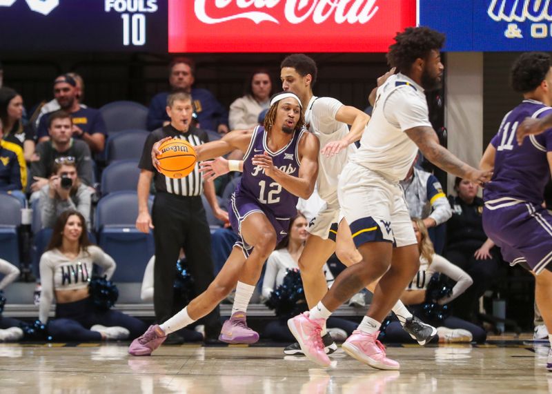 Mar 6, 2024; Morgantown, West Virginia, USA; TCU Horned Frogs forward Xavier Cork (12) drives against West Virginia Mountaineers center Jesse Edwards (7) during the second half at WVU Coliseum. Mandatory Credit: Ben Queen-USA TODAY Sports