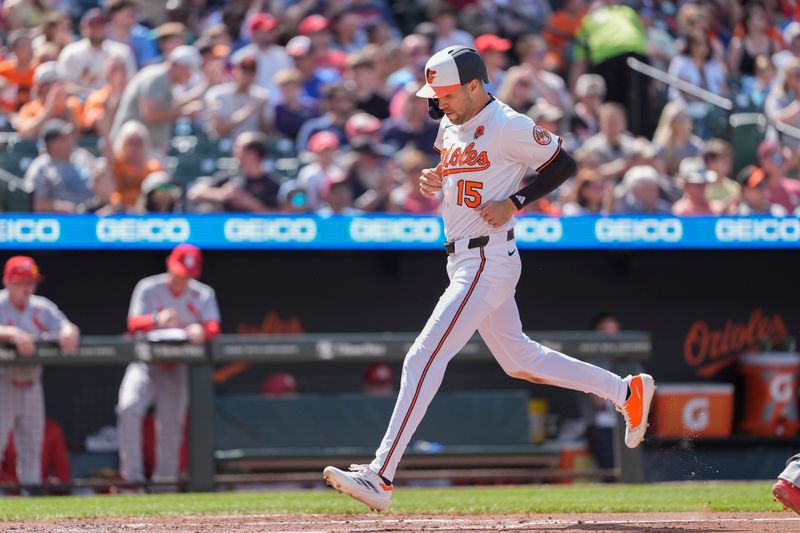 May 26, 2025; Baltimore, Maryland, USA; Baltimore Orioles center fielder Dylan Carlson (15) scores a run on Baltimore Orioles second baseman Jackson Holliday (7) (not pictured) RBI single against the St. Louis Cardinals during the third inning at Oriole Park at Camden Yards. Mandatory Credit: Gregory Fisher-Imagn Images