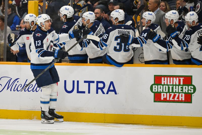 Nov 29, 2025; Nashville, Tennessee, USA;  Winnipeg Jets center Gabriel Vilardi (13) celebrates with his teammates after scoring a goal against the Nashville Predators during the first period at Bridgestone Arena. Mandatory Credit: Steve Roberts-Imagn Images