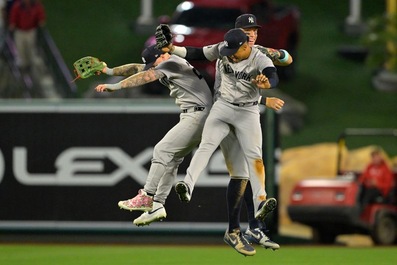 May 29, 2024; Anaheim, California, USA;  New York Yankees left fielder Alex Verdugo (24), center fielder Aaron Judge (99) and right fielder Juan Soto (22) celebrate after the final out of the ninth inning defeating the Los Angeles Angels at Angel Stadium. Mandatory Credit: Jayne Kamin-Oncea-USA TODAY Sports