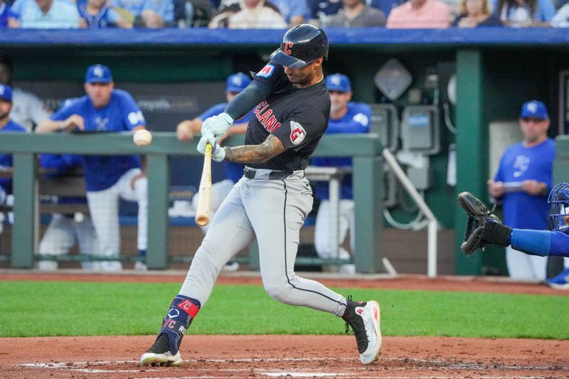 Sep 3, 2024; Kansas City, Missouri, USA; Cleveland Guardians shortstop Brayan Rocchio (4) hits a one-run sacrifice against the Kansas City Royals in the second inning at Kauffman Stadium. Mandatory Credit: Denny Medley-Imagn Images